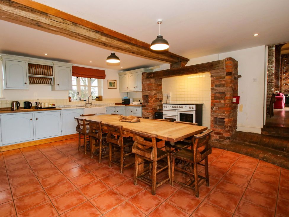 A kitchen with wooden table and chairs at Windy Mundy Farm in Pitchford near Shrewsbury