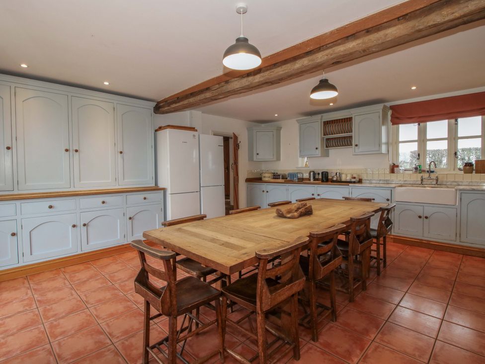 A kitchen with a large table and chairs at Windy Mundy Farm Pitchford near Shrewsbury