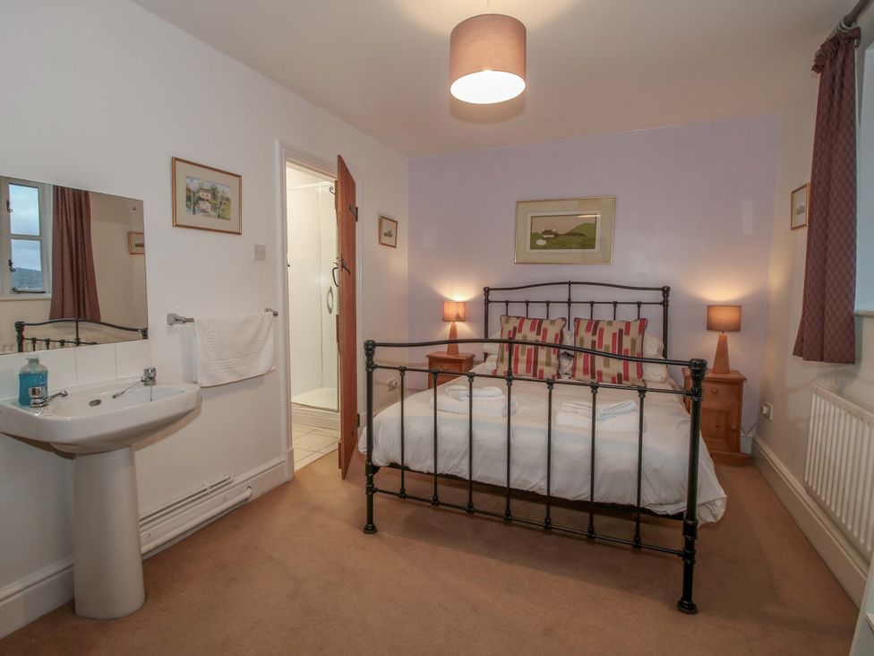 A bedroom with a bed and sink at Windy Mundy Farm in Pitchford near Shrewsbury