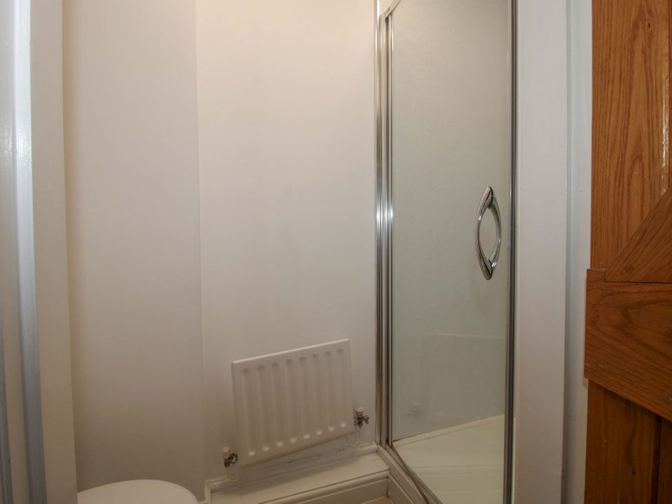 A shower enclosure and toilet in a bathroom at Windy Mundy Farm Pitchford near Shrewsbury