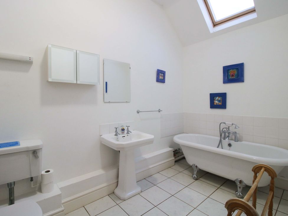 A bathroom with a bathtub, sink, and toilet at Windy Mundy Farm Pitchford near Shrewsbury
