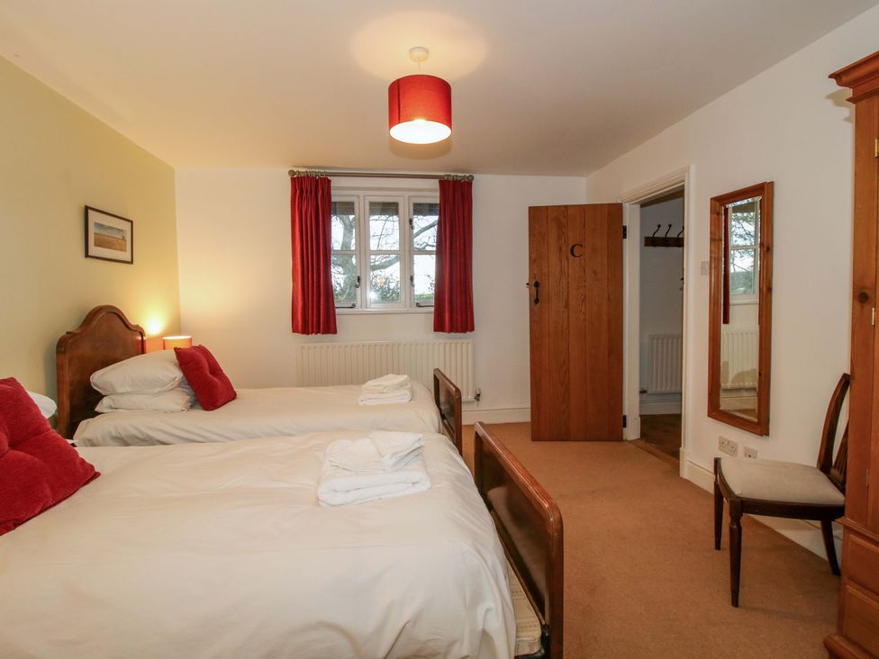 A bedroom with twin beds and a wardrobe at Windy Mundy Farm in Pitchford near Shrewsbury