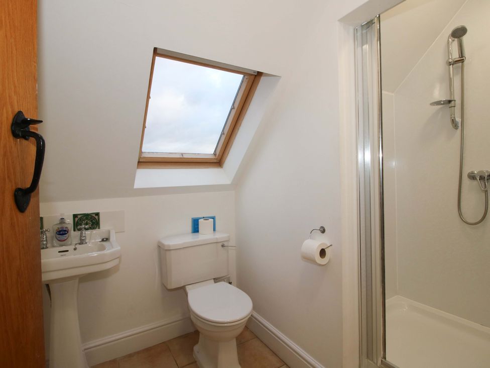 A bathroom with a sink, toilet, and shower at Windy Mundy Farm in Pitchford near Shrewsbury