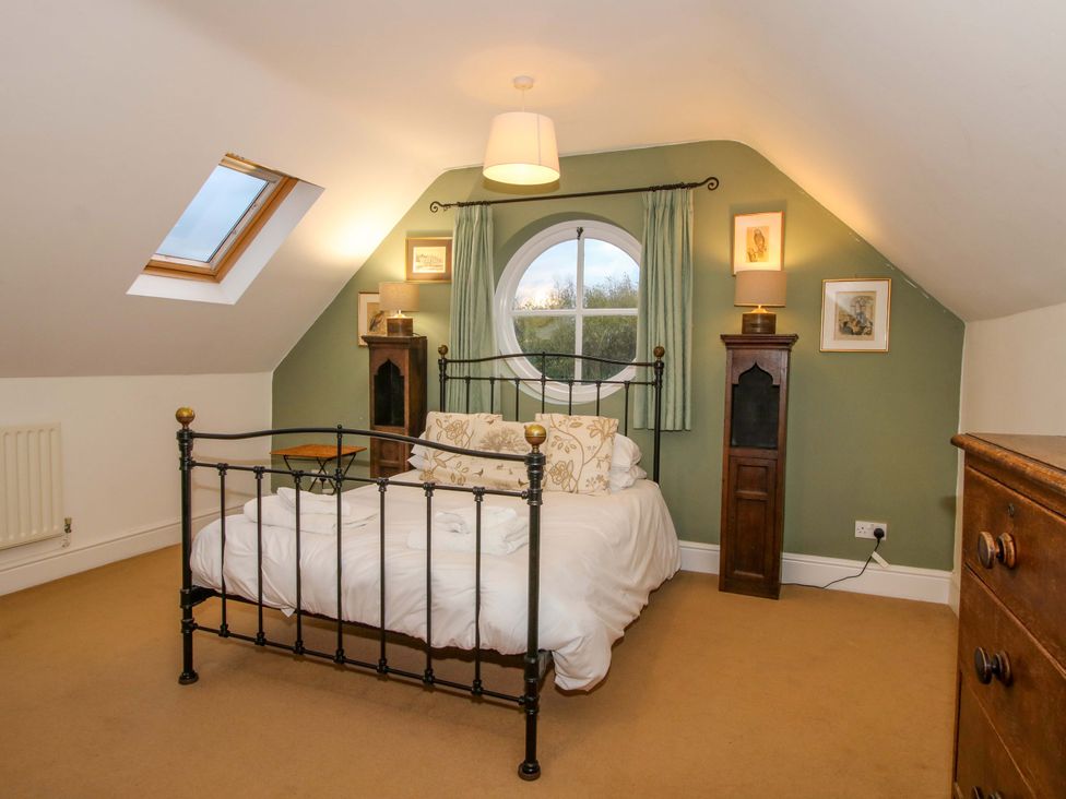 A bedroom with a bed and window at Windy Mundy Farm in Pitchford near Shrewsbury