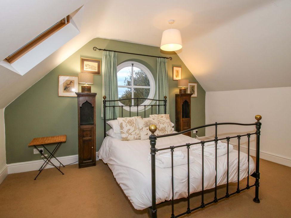 A bedroom with a bed and window at Windy Mundy Farm in Pitchford near Shrewsbury