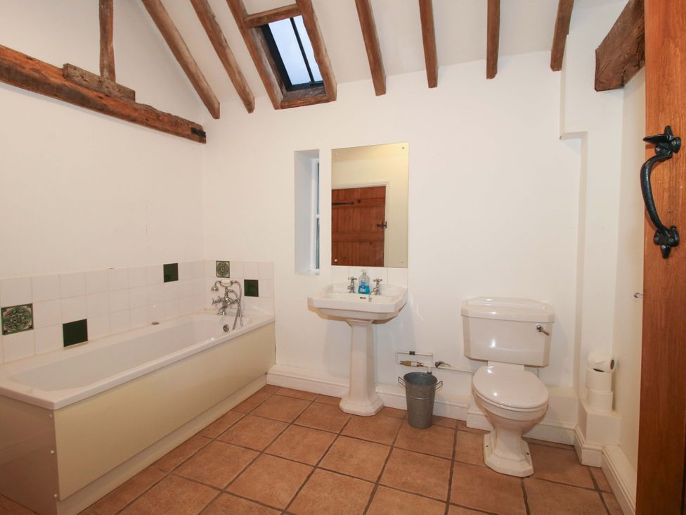A bathroom with a bathtub, sink, and toilet at Windy Mundy Farm in Pitchford near Shrewsbury