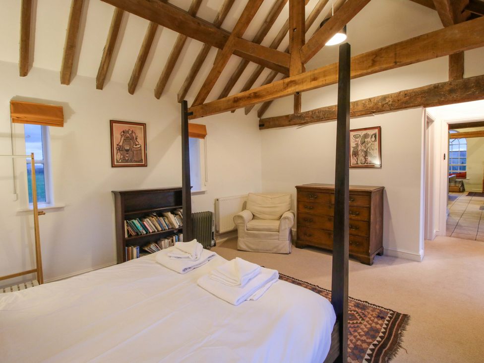 A bedroom with a bed and bookshelf at Windy Mundy Farm Pitchford near Shrewsbury