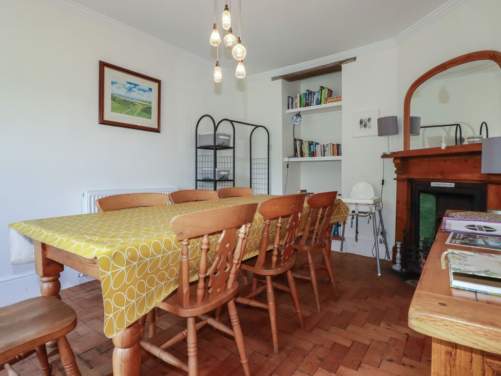 A dining room with a table and chairs at Trevethen Cottage in Crantock