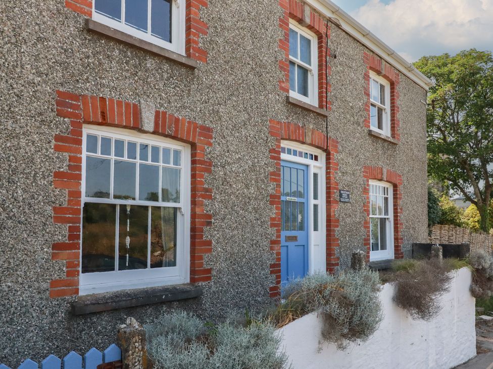 A house exterior with windows and a front door at Trevethen Cottage in Crantock