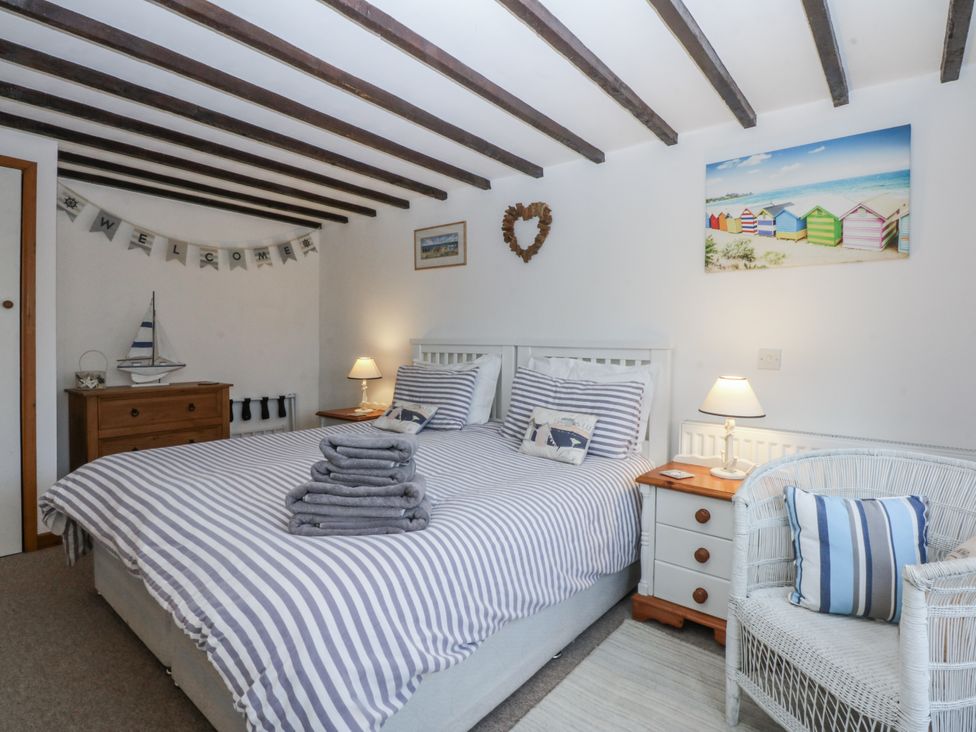 A bedroom with a bed and decorative items at Ty Gwennol in Llanfaethlu