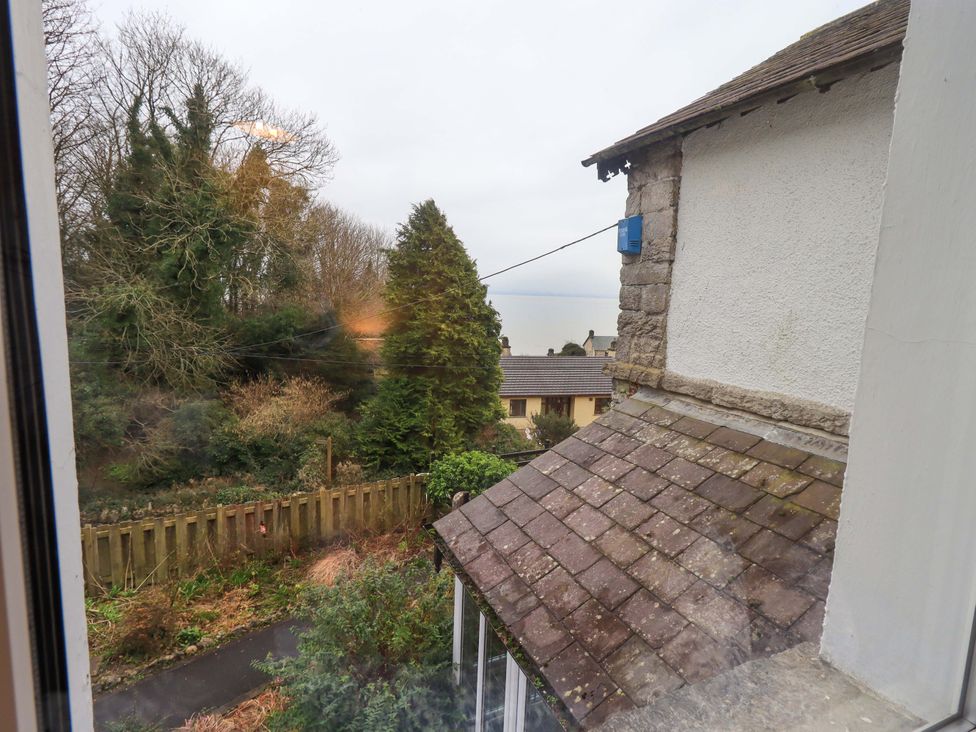 A view of trees and a house from a property at Yewbarrow Cottage Grange-Over-Sands