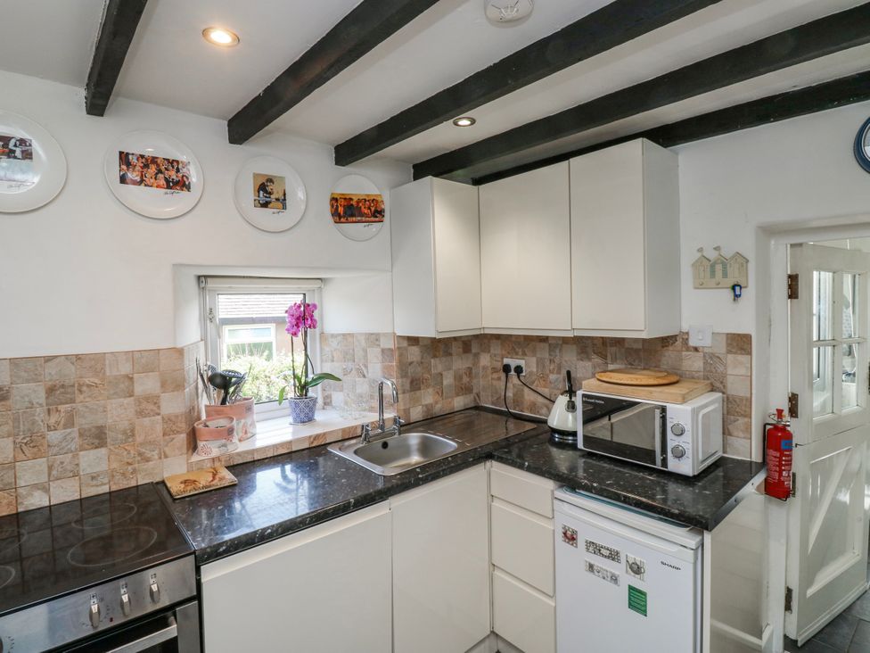 A kitchen with a sink and appliances at 3 Rock Cottages in Kingston