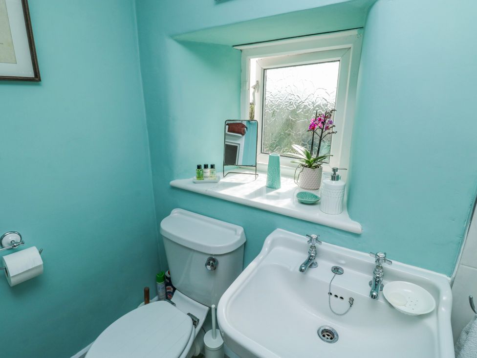 A bathroom with a toilet and sink at 3 Rock Cottages Kingston