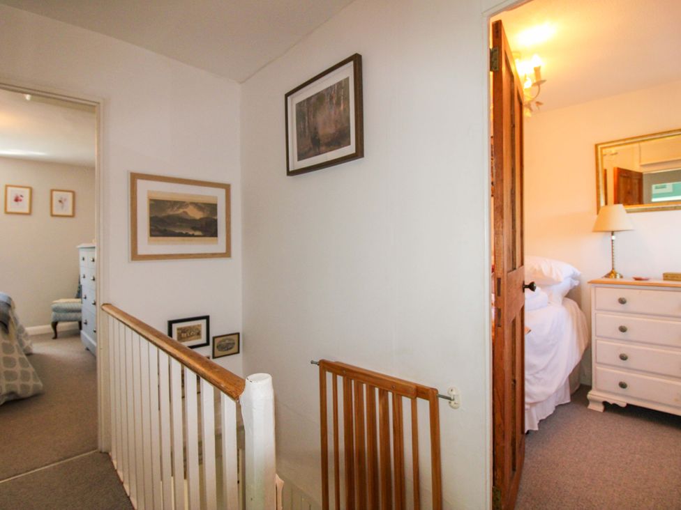 A hallway with a door and dresser at 3 Rock Cottages Kingston