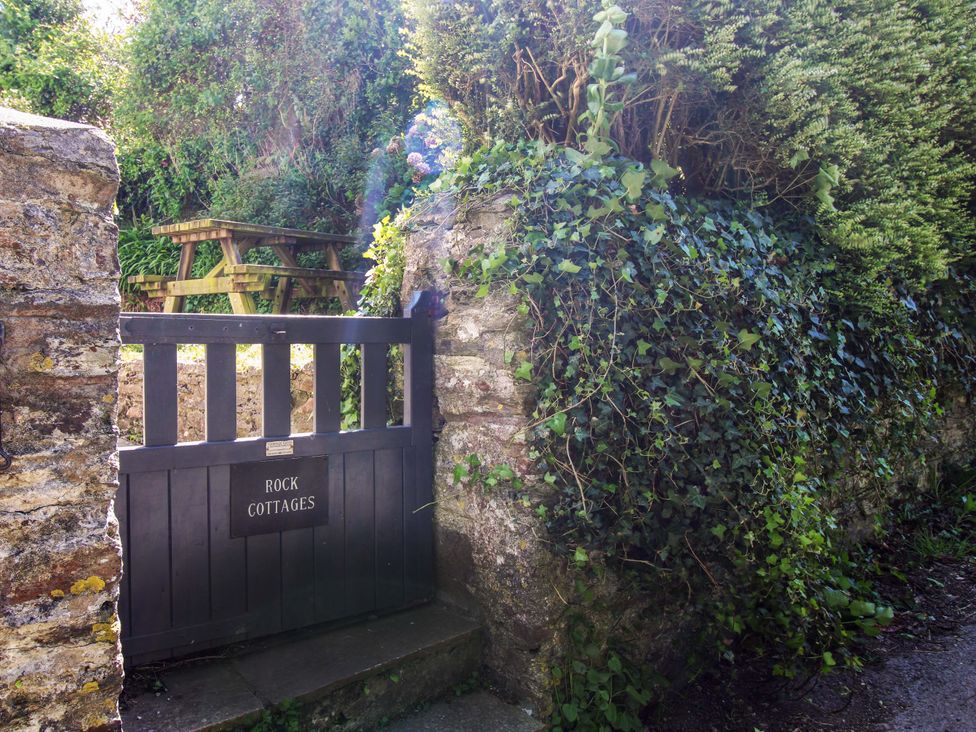 An entrance gate with stone wall and table at 3 Rock Cottages Kingston