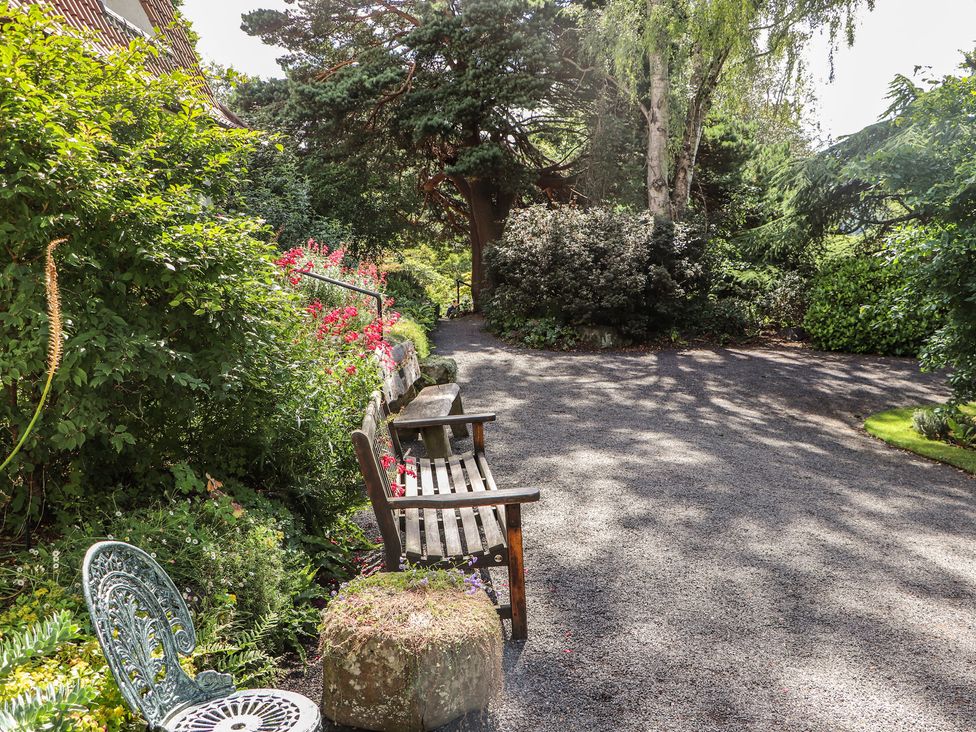 A garden with benches and flower beds at Branklyn Garden Cottage in Perth