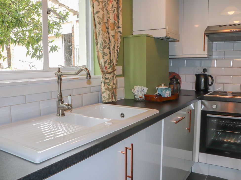 A kitchen with sink and oven at Branklyn Garden Cottage in Perth