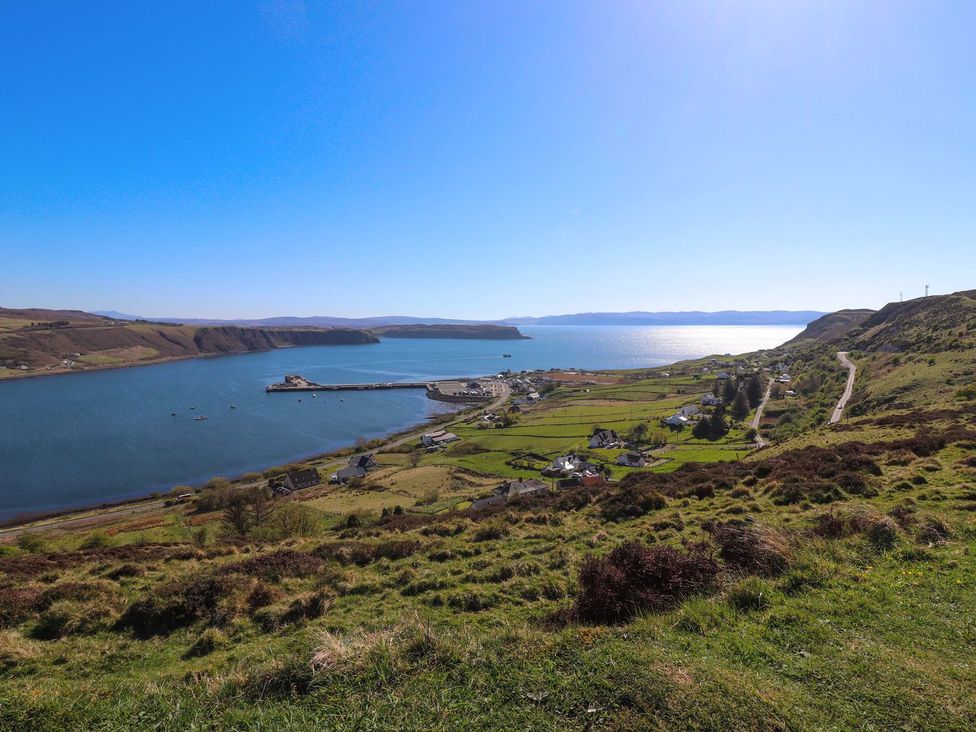 A coastal view with a harbor and houses near the water at Beaton's Croft House - Uig Skye in Kilmuir near Uig
