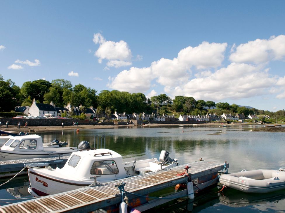 A harbor with boats and houses at Craggan Cottage - Balmacara, Kyle Of Lochalsh