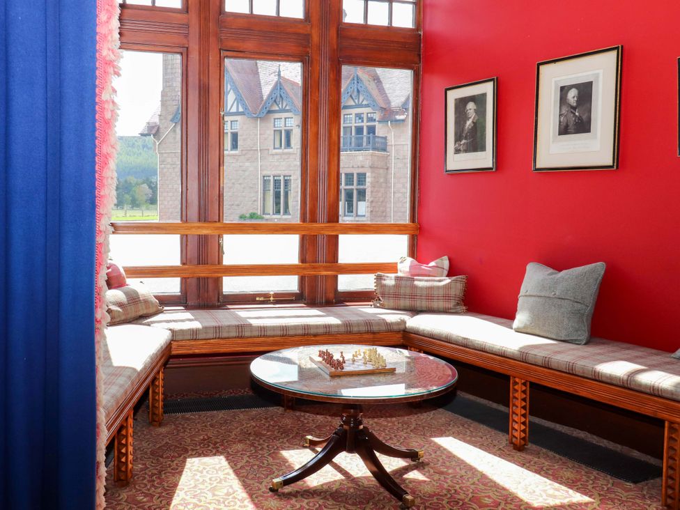 A sitting room with cushioned seating and a chess set on a coffee table at Paye House - Cromarty