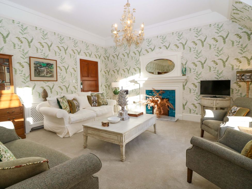 A living room with a coffee table and sofa at Braeriach - Mar Lodge Estate in Braemar