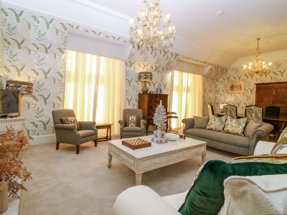 A living room with a sofa and chairs at Braeriach - Mar Lodge Estate, Braemar