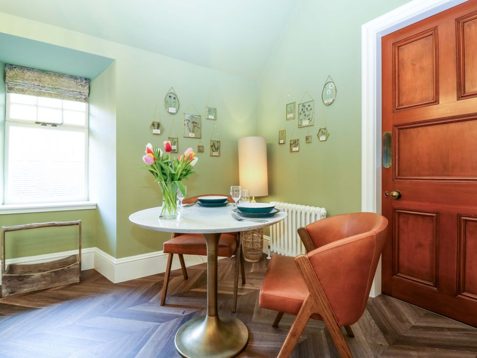 A dining room with a table and chairs at Braeriach - Mar Lodge Estate in Braemar