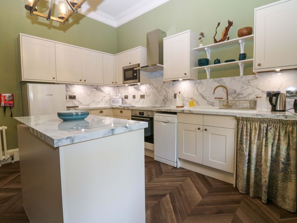 A kitchen with appliances and cabinets at Braeriach - Mar Lodge Estate Braemar