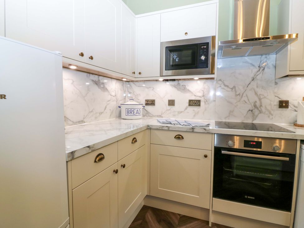 A kitchen with modern appliances and cabinetry at Braeriach - Mar Lodge Estate, Braemar
