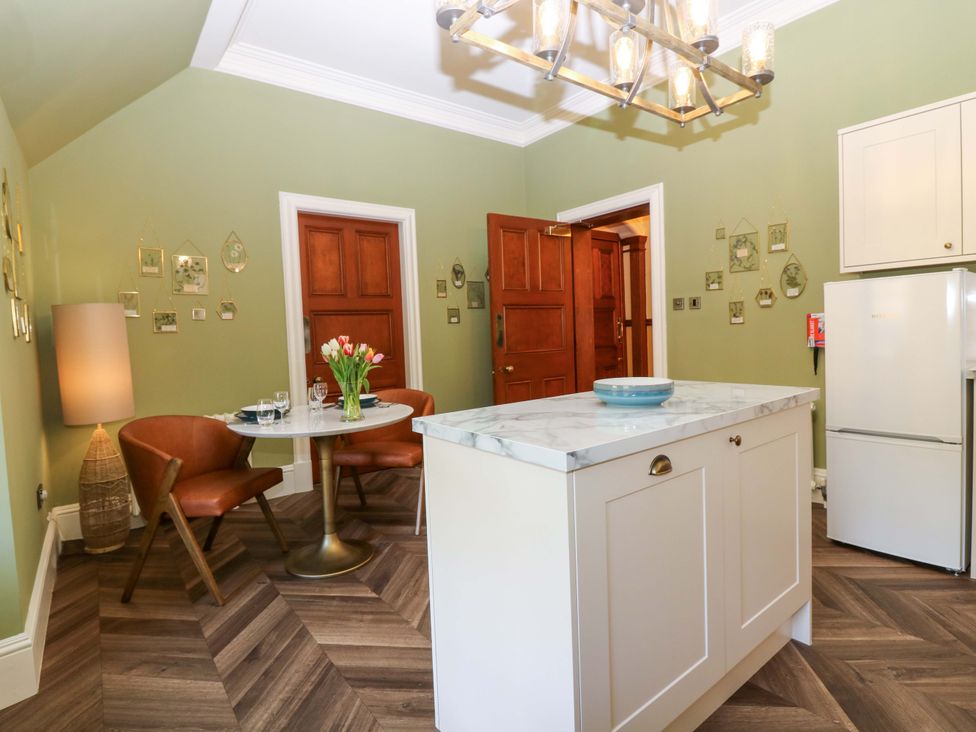 A kitchen with a table and chairs at Braeriach - Mar Lodge Estate, Braemar