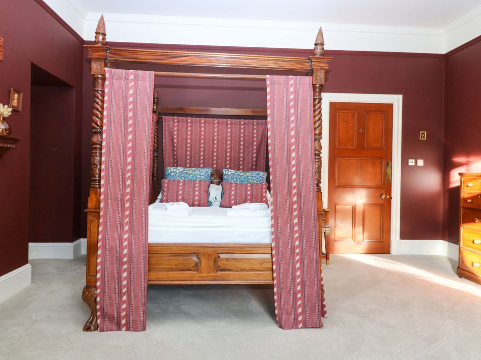 A bedroom with a four-poster bed and a dresser at Braeriach - Mar Lodge Estate, Braemar