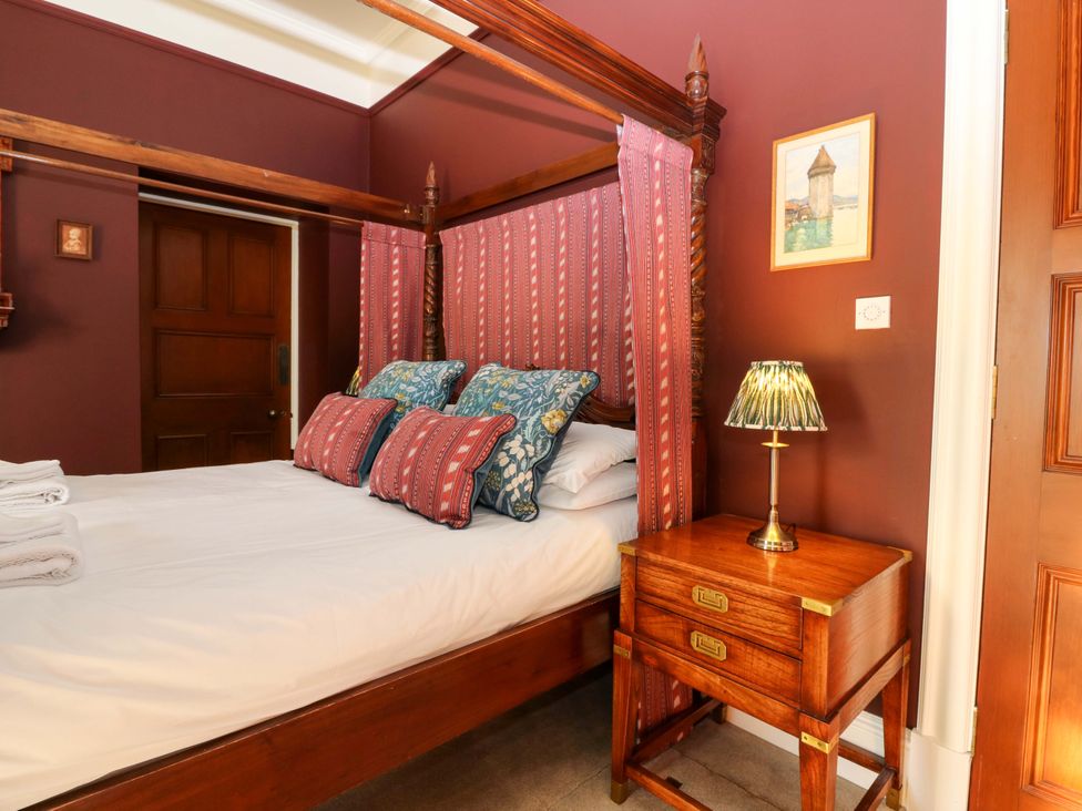 A bedroom with a bed and bedside table at Braeriach - Mar Lodge Estate in Braemar