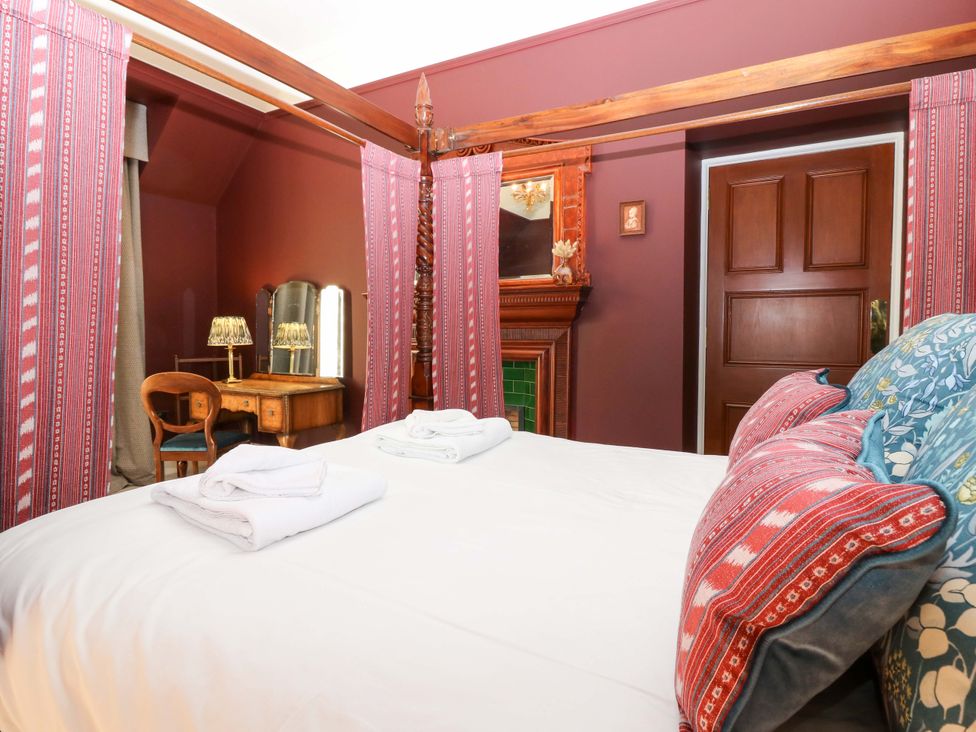 A bedroom with a four-poster bed and dresser at Braeriach - Mar Lodge Estate in Braemar