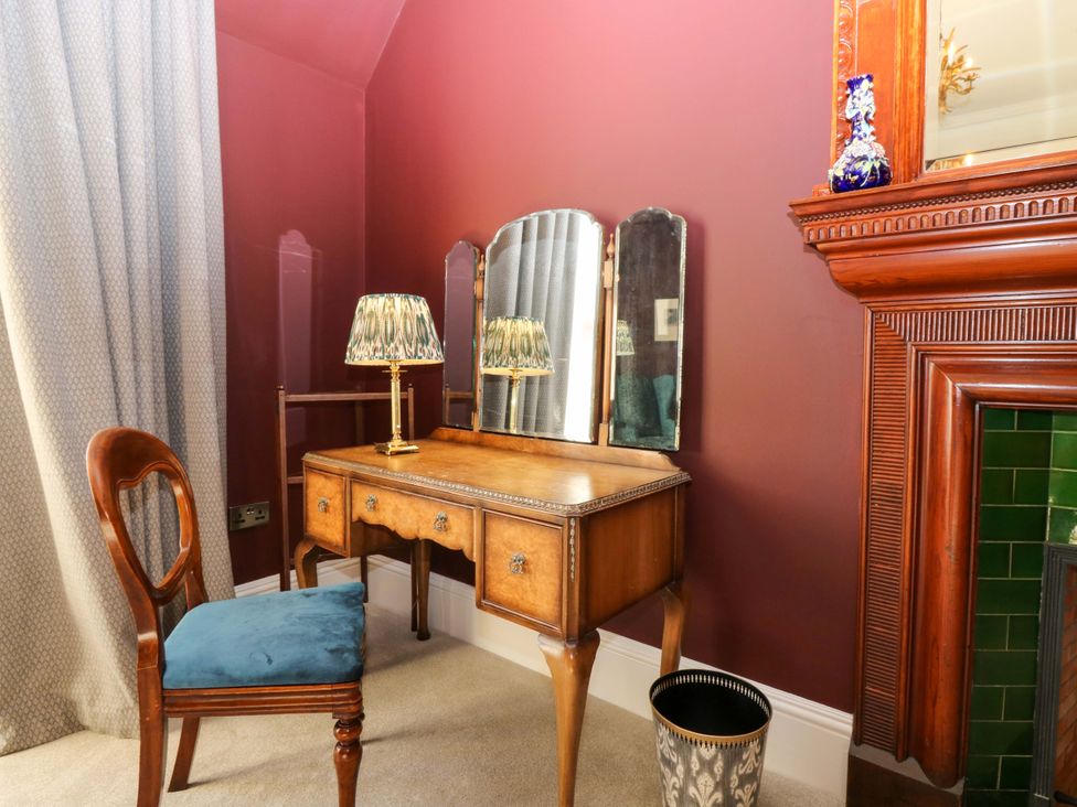 A dressing room with a vanity table and chair at Braeriach - Mar Lodge Estate in Braemar