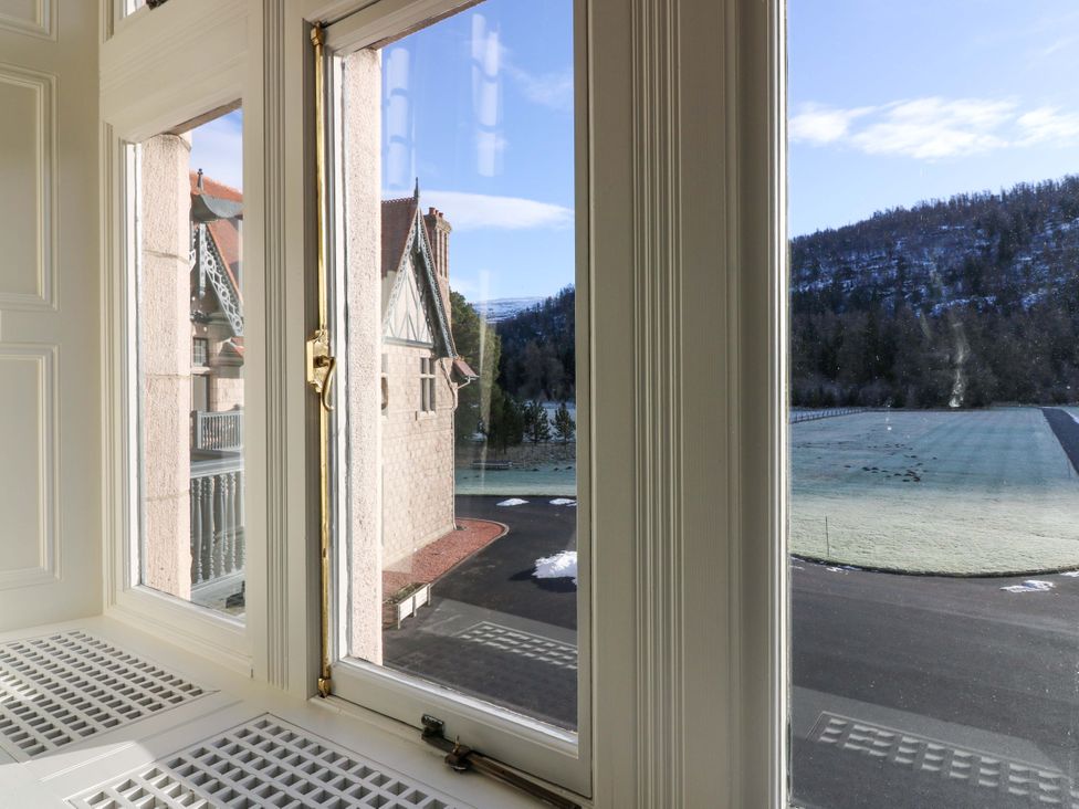 A view from a window showing a building and landscape at Braeriach - Mar Lodge Estate in Braemar