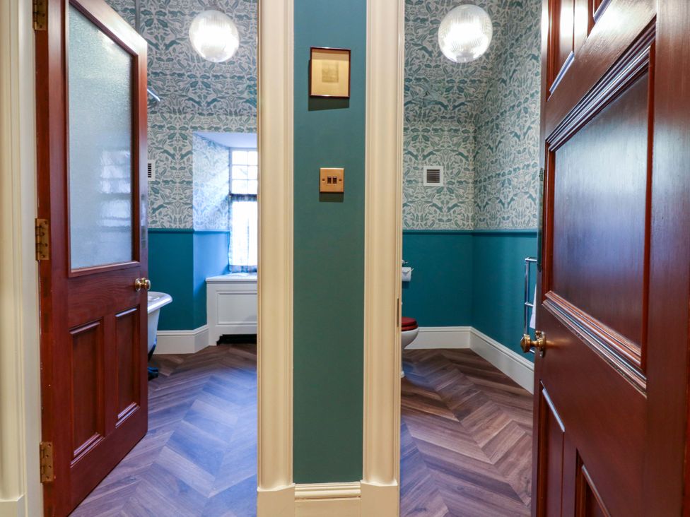 A bathroom with door and window at Braeriach - Mar Lodge Estate in Braemar