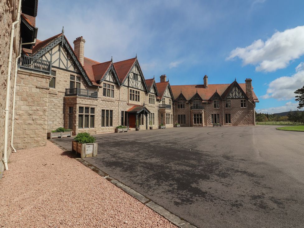 An exterior view of a stone building with a driveway at Braeriach - Mar Lodge Estate in Braemar