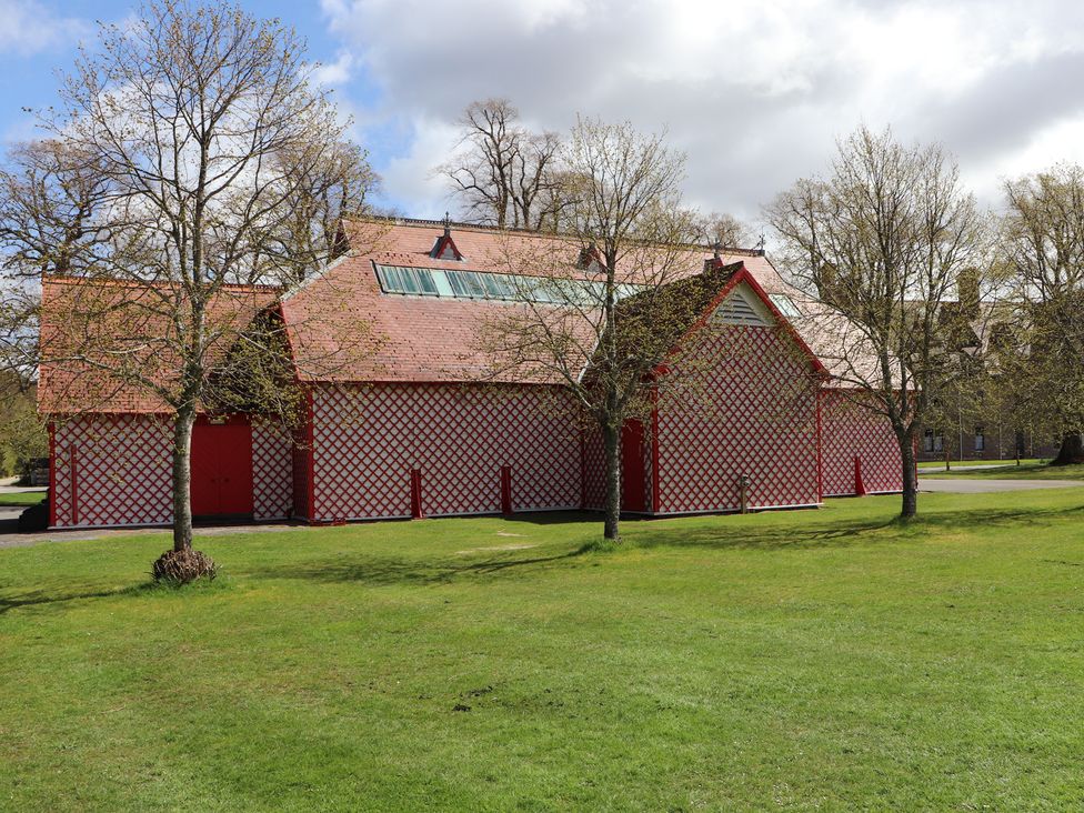 A building with a patterned exterior and trees in an outdoor area at Braeriach - Mar Lodge Estate, Braemar
