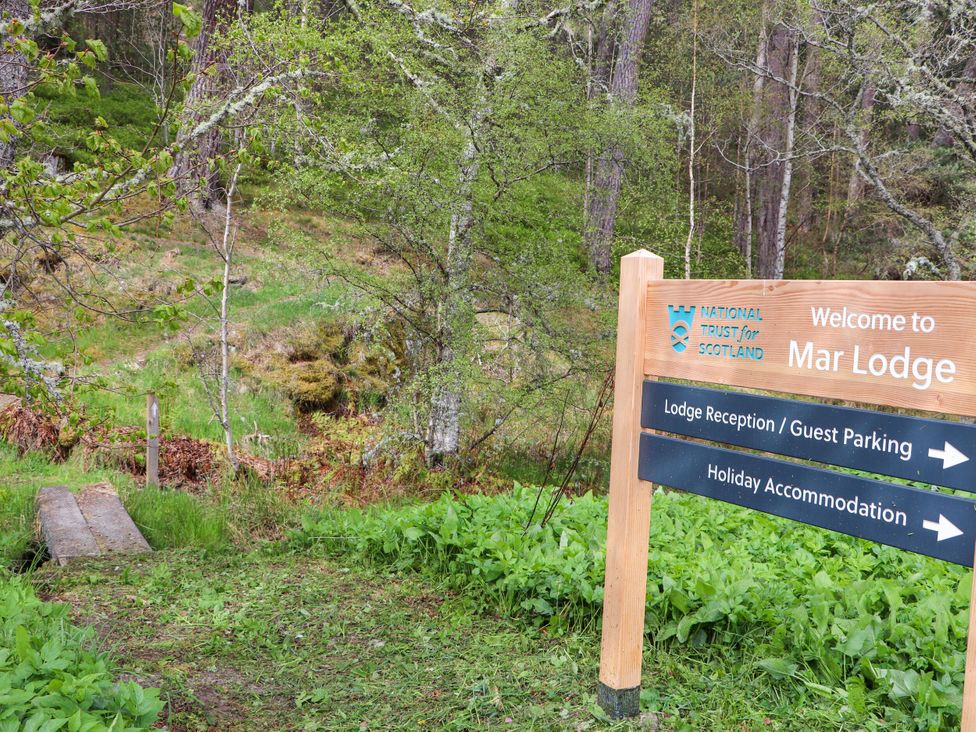 A sign post at Mar Lodge with directions to guest parking and accommodation at Mar Lodge Estate in Braemar