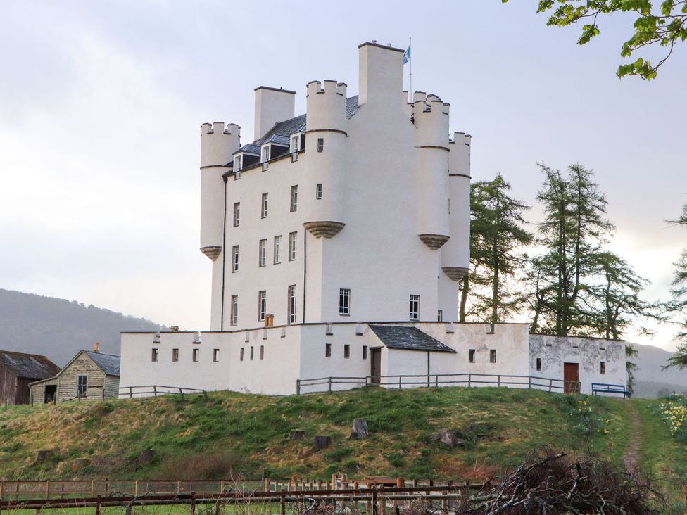 A castle with turrets and a fence at Bynack - Mar Lodge Estate, Braemar