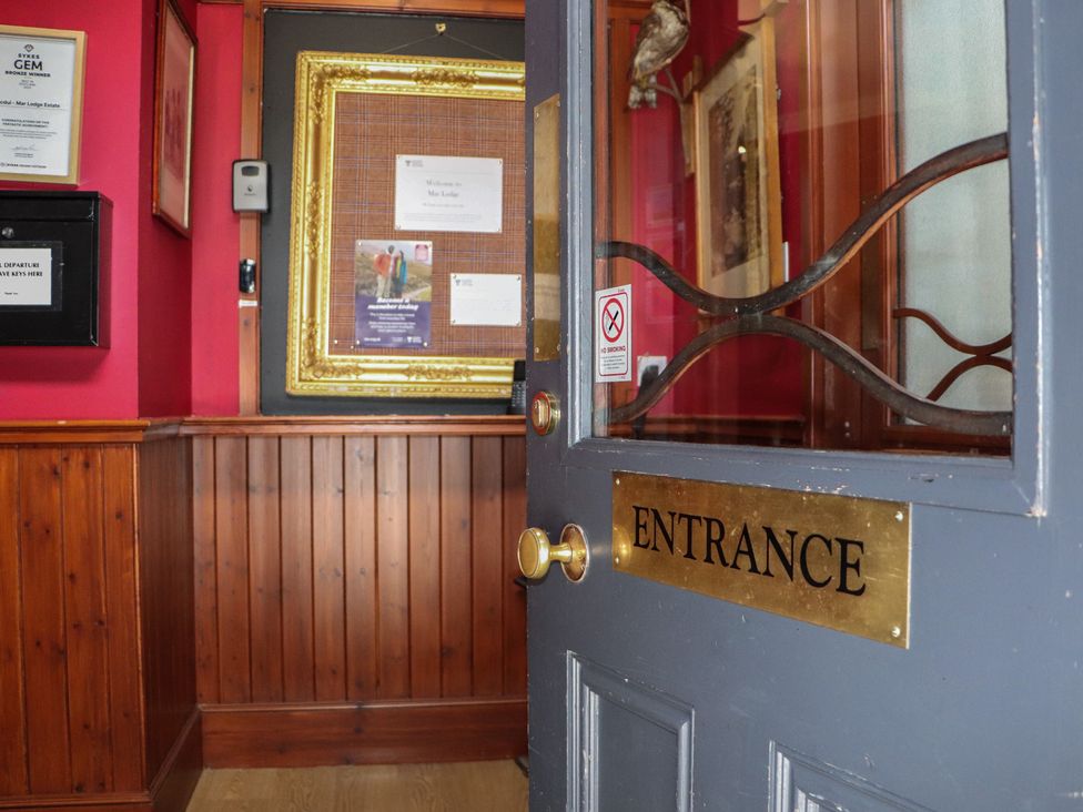 An entrance area with a door and wall decor at Bynack - Mar Lodge Estate, Braemar
