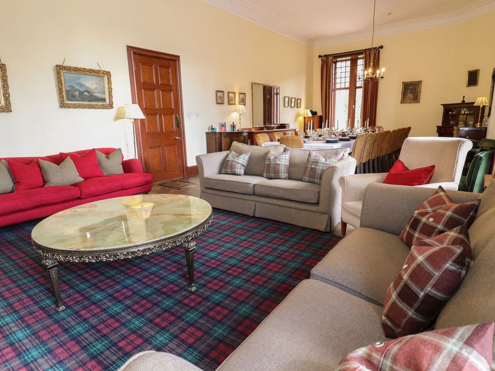 A living room with couches, coffee table, and dining area at Bynack - Mar Lodge Estate, Braemar
