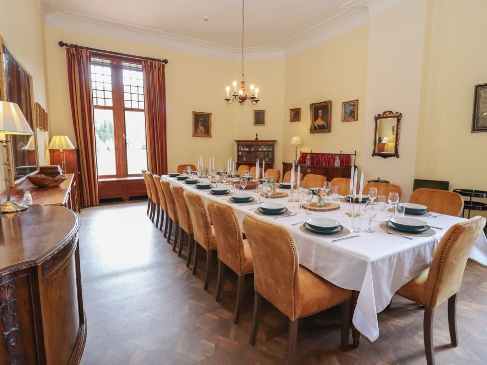 A dining room with a long table set for a meal at Bynack - Mar Lodge Estate, Braemar