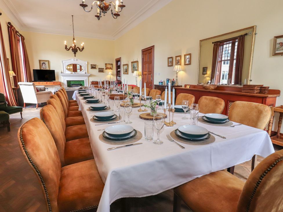 A dining room with a long table set for meals at Bynack - Mar Lodge Estate in Braemar