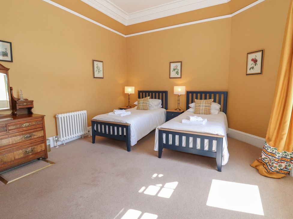 A bedroom with two beds and a chest of drawers at Bynack - Mar Lodge Estate Braemar