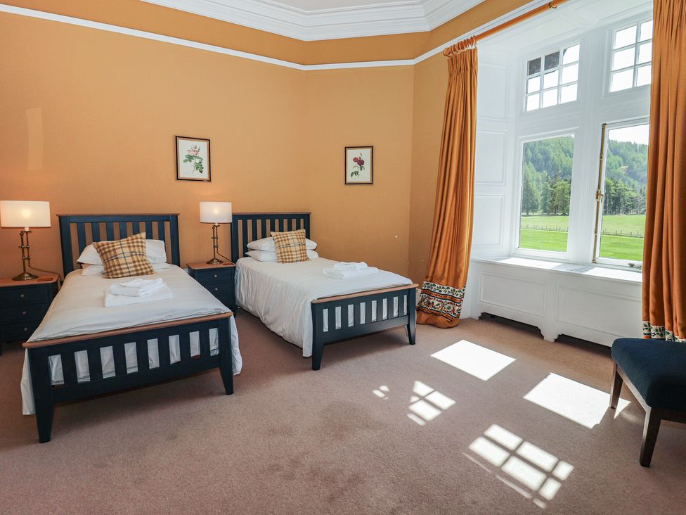 A bedroom with two beds and a window at Bynack - Mar Lodge Estate, Braemar