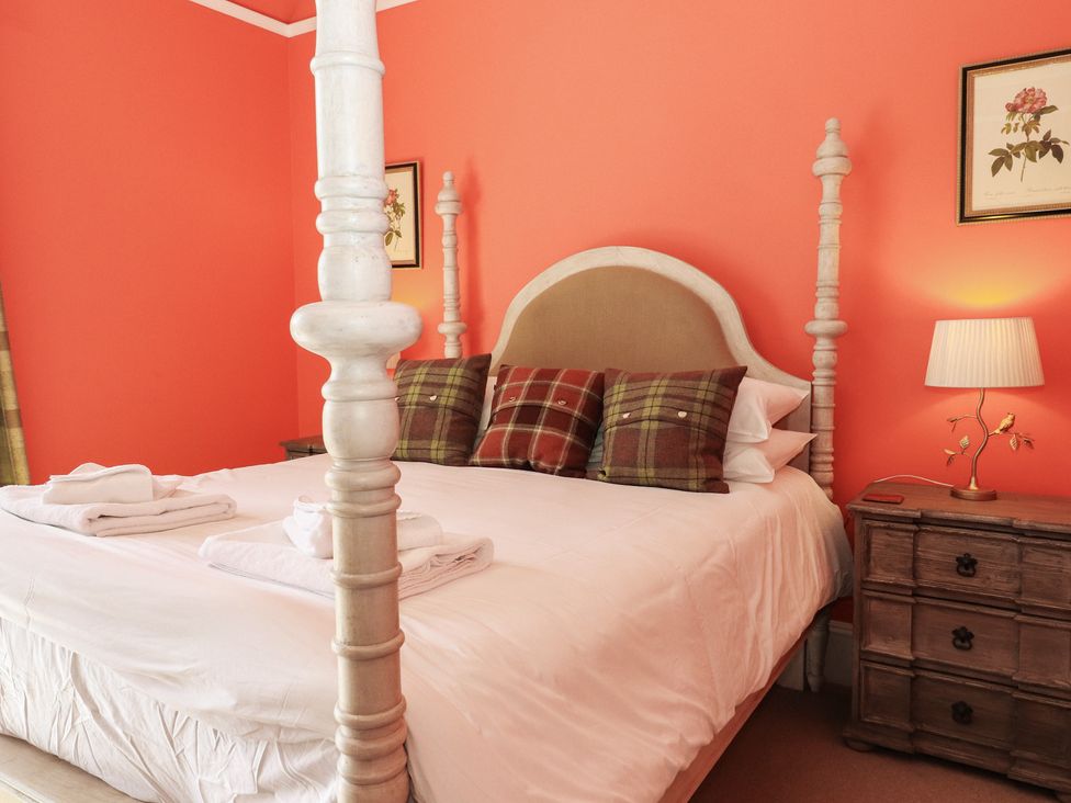A bedroom with a bed and bedside lamp at Bynack - Mar Lodge Estate in Braemar