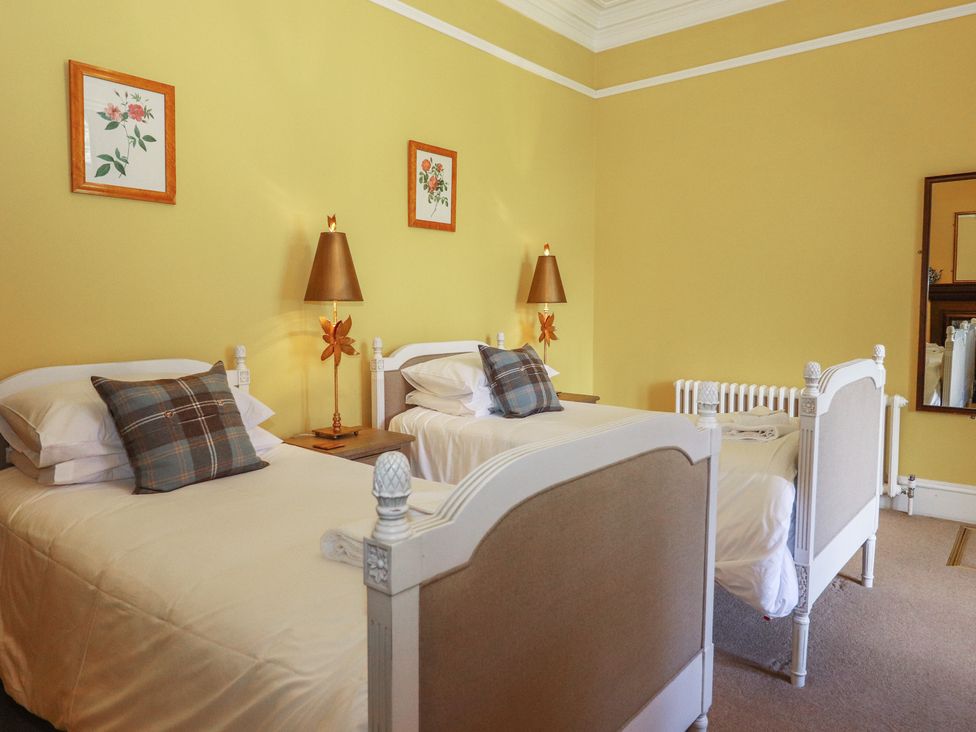 A bedroom with two beds and wall art at Bynack - Mar Lodge Estate, Braemar