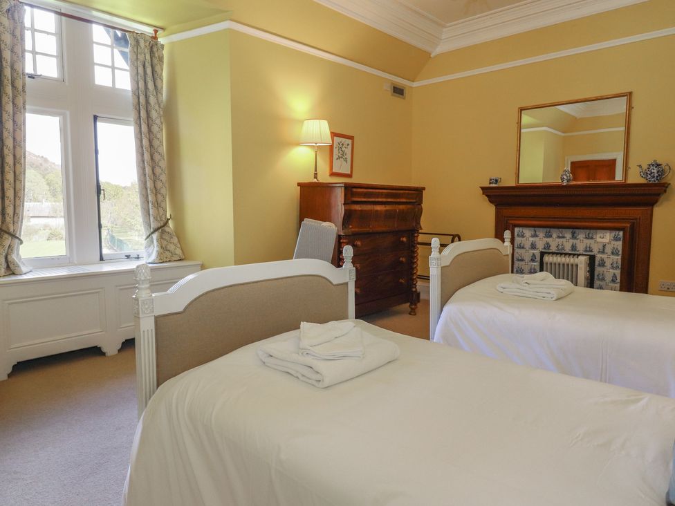 A bedroom with two beds and a dresser at Bynack - Mar Lodge Estate, Braemar