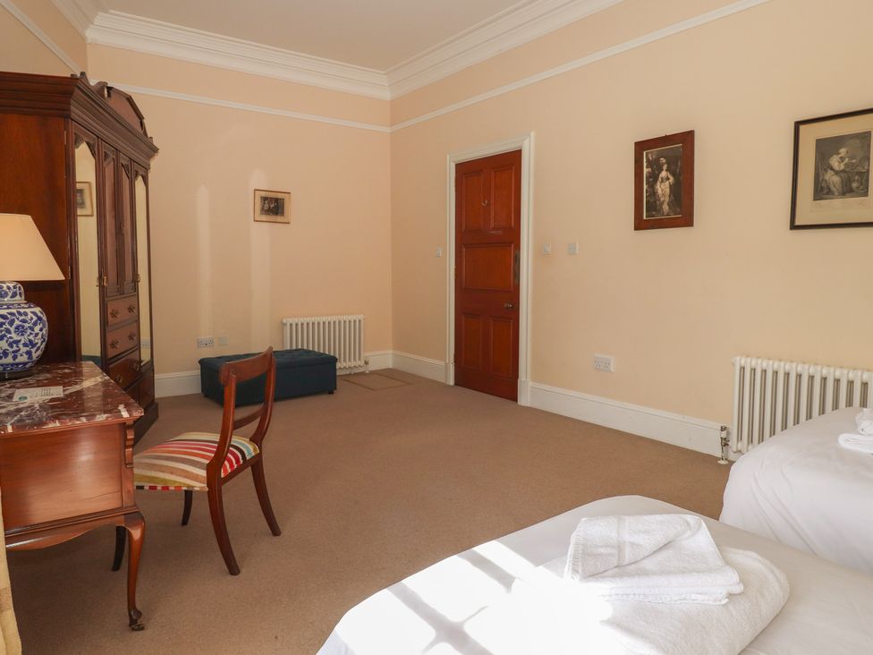 A bedroom with a bed, chair, and dresser at Bynack - Mar Lodge Estate, Braemar
